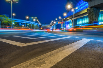 Empty asphalt road through modern city at night, china