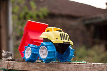multi-colored children's car, children's truck on the street