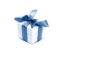A gift box isolated over white background with copy space. Box is tied with a ribbon. Tinted by 2020 year Classic Blue color. Valentine`s Day, 8 March, Mother and Women Day concept