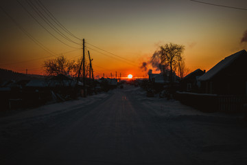  Siberian village in winter at sunset