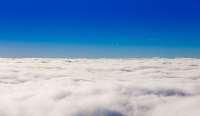 above the clouds view of blue sky background