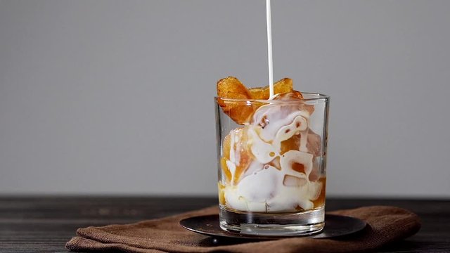 Pouring cream in iced coffee