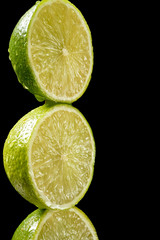 Green fresh organic kiwi halves on black background