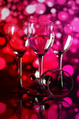 Two glasses of champagne with lights in the background. very shallow depth of field, focus on near glass.