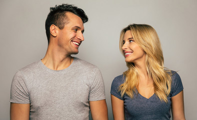 The love of my life. Close-up photo of a tall man and a good-looking woman, who are gently looking into each other’s eyes and smiling, while posing in front.