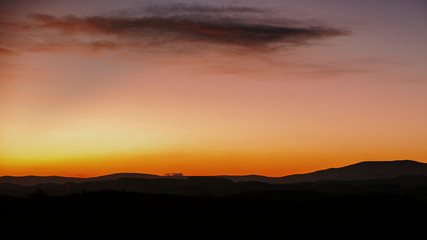 sunrise on the meadow with hills in background