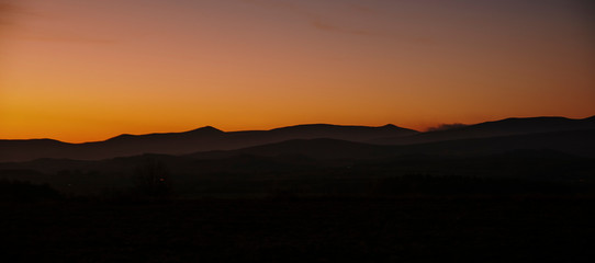 sunrise on the meadow with hills in background