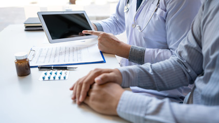 Doctor explaining and giving a consultation to a patient medical informations and diagnosis about the treatment for condition in hospital, medical ethics concept.