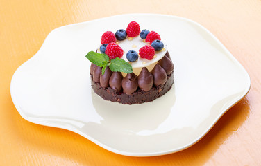 Shortbread chocolate tart with Panna cotta and jam fresh raspberries