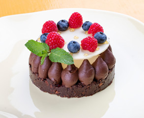 Shortbread chocolate tart with Panna cotta and jam fresh raspberries