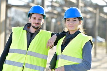 Portrait of young people apprentice standing on building site