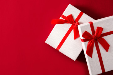 Assorted white gift boxes on red background.	Top view. Copy space