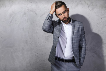 Handsome bearded man wearing gray checkered suit