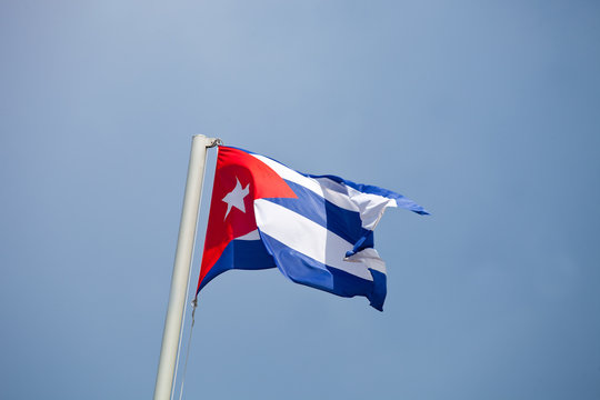 Flag of Cuba waving against blue sky