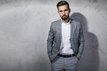 Handsome bearded man wearing gray checkered suit