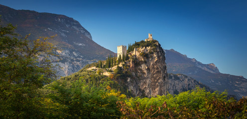 Amazing ruins of Arco Castle on the rock in northern Italy. - obrazy, fototapety, plakaty