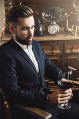 Handsome bearded man with a glass of red wine