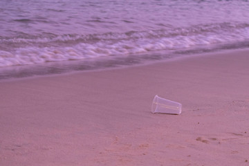 Naklejka premium Plastic scraps left over by people on the beach in the evening. Is what causes environmental problems