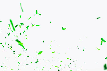 Green confetti elements on a white background. Confetti shot at a party, anniversary go birthday. Festive mood. Festive decor - obrazy, fototapety, plakaty