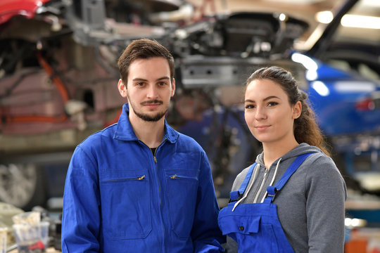 Apprentice working in automobile workshop