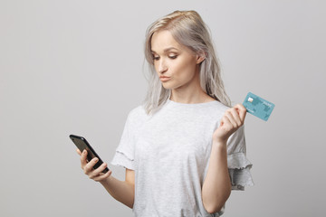 Pretty woman with phone and credit card. Online shopping concept