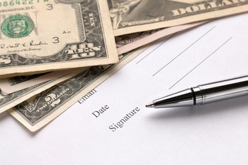 Signing a document. Dollar background