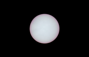 Detailed view of sun with sunspots and black sky