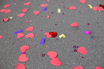 Background with glitter heart confetti. Valentine day concept. Trendy minimalistic flat lay design background. Horizontal image.Happy Valentine's day concept, many red hearts on a gray background