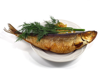 Smoked sea fish and a bunch of dill on a plate. White background.