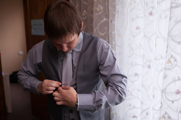 Young groom in a suit of gray tones