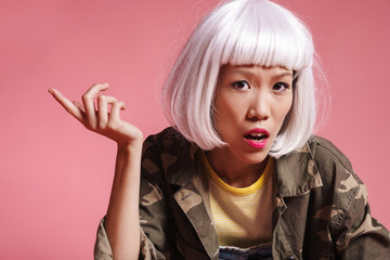 Image of asian girl wearing wig resenting and gesturing in indignation