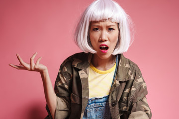 Image of asian girl wearing wig resenting and gesturing in indignation
