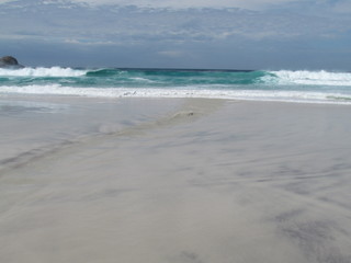 Summer morning at the beach during the return of the tide.