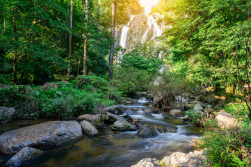 A beautiful waterfall deep in the tropical forest, steep mountain adventure in the rainforest.
