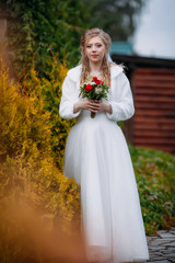 Fototapeta na wymiar Young beautiful bride in a wedding dress