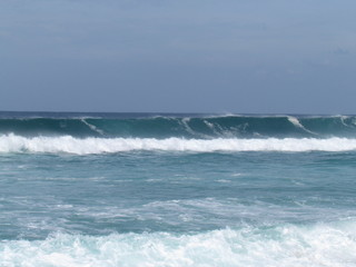 Summer morning at the beach with high tide and high winds.