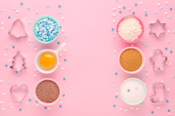 ingredients and cookie cutter on pink background, flat lay