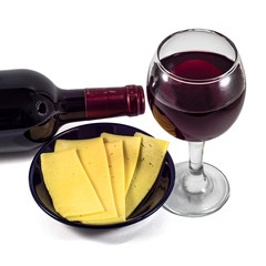 Glass, bottle of red wine, cheese in a plate on a white background