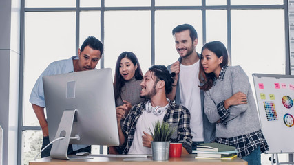 Creative director team surprise for good news of project with designer at meeting table with...