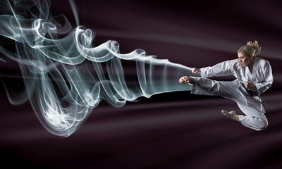 Composite image of karate girl jumping