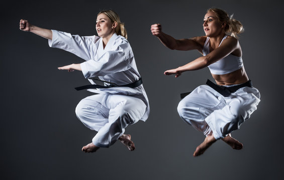 Two women athletes training karate