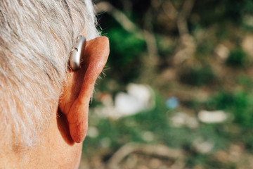 senior man wearing a hearing aid