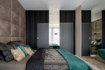 Bedroom with mirrored and upholstered walls