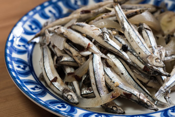 Paksiw na dilis is a Filipino dish of simmered anchovies in vinegar with spices like garlic, onion and ginger. 