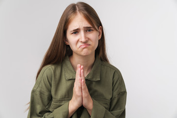 Photo of caucasian unhappy woman holding palms together