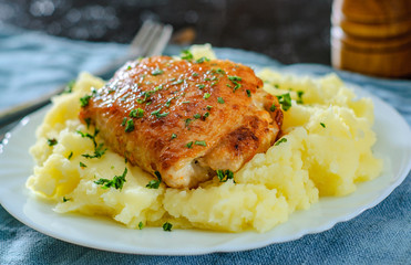 Roasted chicken breast roll stuffed with chicken and pork meat with mashed potatoes in white plate on table