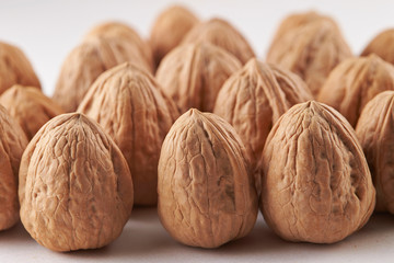Heap of walnuts on white background