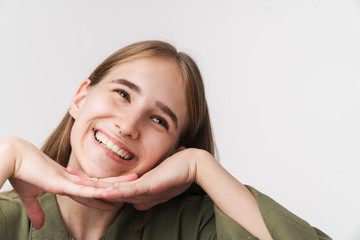 Photo of funny caucasian woman looking upward and smiling