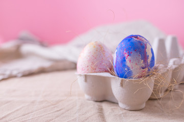 Two easter eggs decorated with watercolour aquarelle classic blue color, minimalism style on pink background. Easter holiday decorations with copy space
