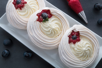 Cakes on a white plate standing on the table.